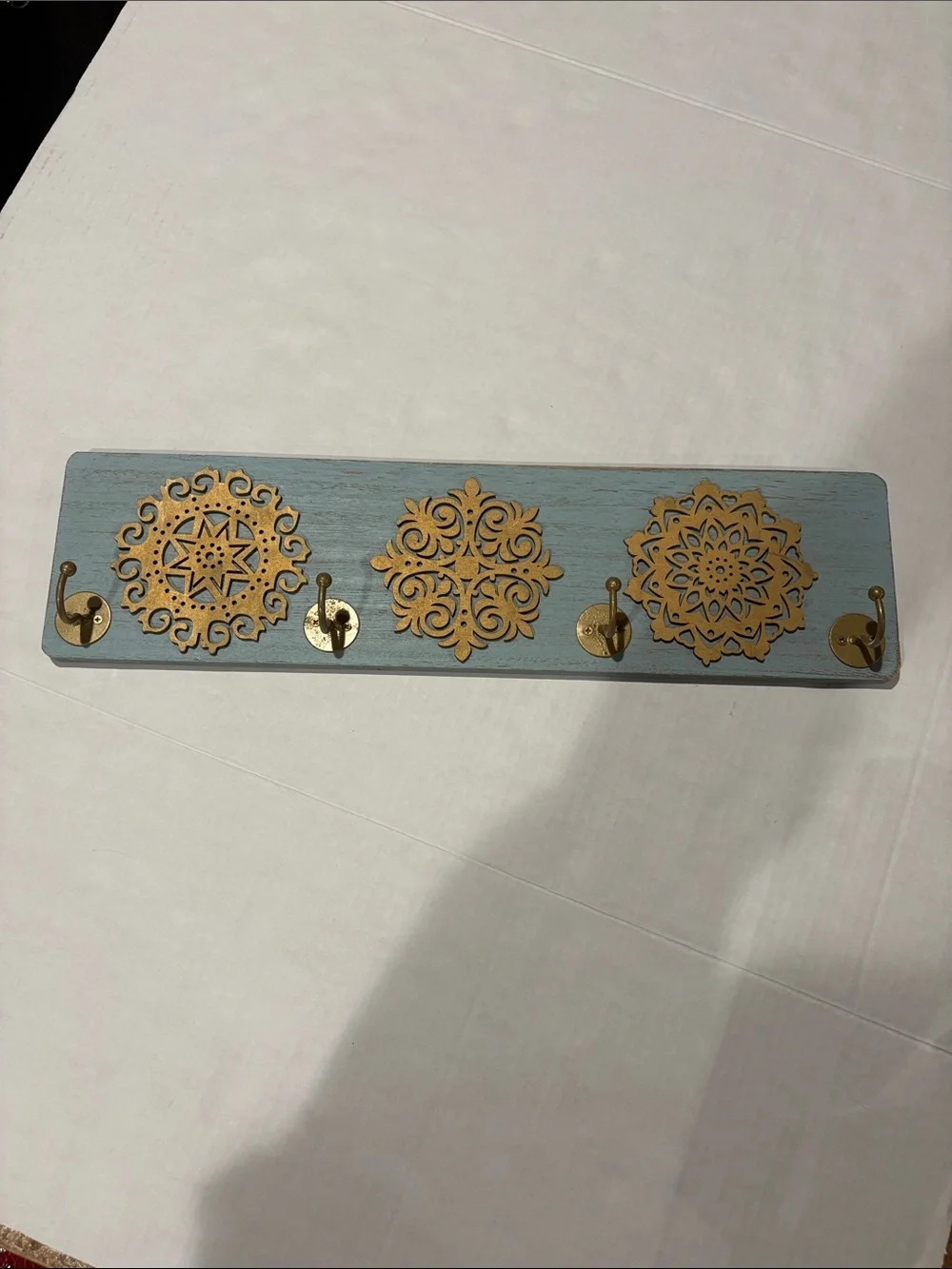 Blue Wall Hook Rack with Gold Medallion Accents